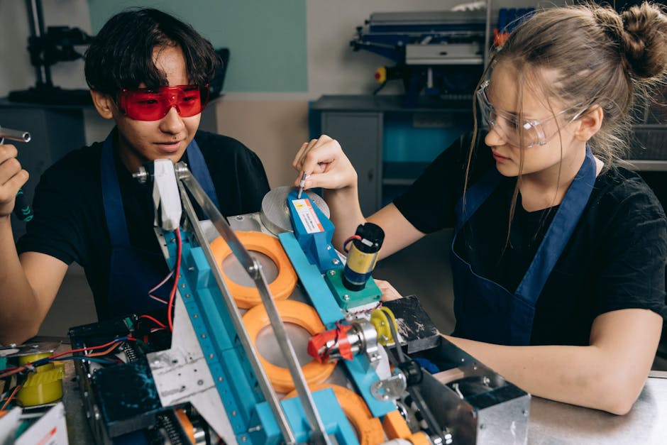 Two students collaborating on a robotics project in a tech lab, focusing on machinery details